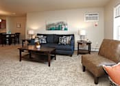 Thumbnail 2 of 21 - Carpeted Living Room with Couch and Coffee Table