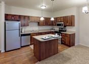 Thumbnail 1 of 21 - a kitchen with stainless steel appliances and wooden cabinets