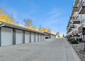 Thumbnail 23 of 27 - A row of garage doors in a parking lot.