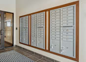 Thumbnail 27 of 27 - A set of mailboxes are lined up on a wall.