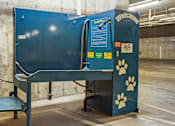 Thumbnail 24 of 27 - A blue and black dog kennel with a welcome sign and paw prints.