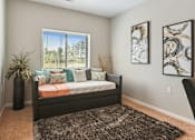 Thumbnail 7 of 27 - A bedroom with a bed, pillows, a carpet, and two pieces of artwork on the wall.