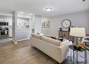 Thumbnail 4 of 26 - an open living room and kitchen with a large clock on the wall