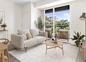 Thumbnail 2 of 31 - A living room with a grey couch, a wooden table, and a sliding glass door.