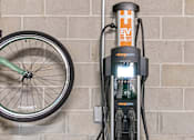 Thumbnail 28 of 31 - A bicycle is parked next to a charging station.