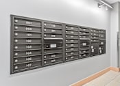 Thumbnail 19 of 31 - A wall of mailboxes numbered from 001 to 204.