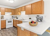 Thumbnail 5 of 14 - a spacious kitchen with white appliances and wooden cabinets