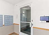 Thumbnail 13 of 14 - a locker room with an open door and a door to the mail room