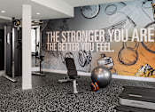 Thumbnail 15 of 34 - A gym room with a motivational quote on the wall.