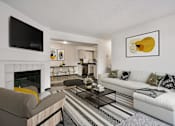 Thumbnail 7 of 20 - Furnished Living Room with Large Couch, Coffee Table and TV