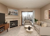 Thumbnail 4 of 20 - Furnished Living Room with Fireplace and Sliding Glass Door