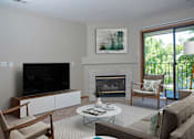 Thumbnail 5 of 20 - Furnished Living Room with Fireplace and Sliding Glass Door