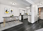 Thumbnail 2 of 20 - Kitchen and Dining Room with White Cabinets and Dark Hard Wood Flooring
