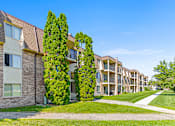 Thumbnail 16 of 18 - an apartment building with two trees in front of it