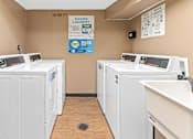 Thumbnail 8 of 18 - four washers and dryers in a laundry room with two sinks and three was