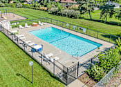 Thumbnail 9 of 18 - a swimming pool in a backyard with a fence around it
