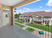 Thumbnail 15 of 24 - the view from the balcony of a house with a yard and a white door