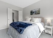 Thumbnail 10 of 36 - A bedroom with a large bed and a painting on the wall.