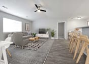 Thumbnail 14 of 33 - Wide view of living room filled with natural light from the large window above the gray couch.