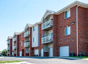 Thumbnail 30 of 33 - Exterior of select units featuring private garage entrances and driveway.