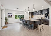 Thumbnail 14 of 32 - A kitchen with a large island and chairs.