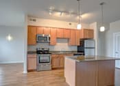 Thumbnail 14 of 20 - a kitchen with wooden cabinets and stainless steel appliances