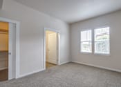 Thumbnail 13 of 20 - a bedroom with two windows and an open door