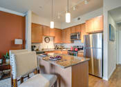 Thumbnail 16 of 20 - a kitchen with an island and stainless steel appliances