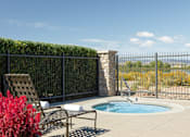 Thumbnail 6 of 20 - a jacuzzi and chairs on a patio next to a pool