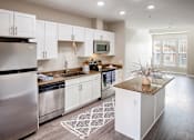 Thumbnail 3 of 20 - an open kitchen with stainless steel appliances and white cabinets