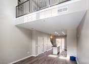 Thumbnail 18 of 20 - a spacious living room with a balcony and a kitchen