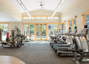 Thumbnail 7 of 20 - the gym has plenty of cardio equipment and glass doors to the pool