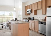 Thumbnail 4 of 20 - a kitchen with wooden cabinets and stainless steel appliances