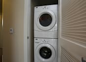 Thumbnail 19 of 20 - a front loading washer and dryer in a laundry room