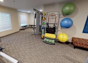 Thumbnail 11 of 15 - a gym with weights and exercise equipment at the monarch apartments in midtown