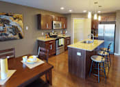 Thumbnail 1 of 15 - a kitchen and dining room with a wooden table