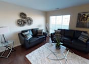 Thumbnail 5 of 15 - a living room with black leather furniture and a white rug