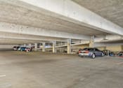 Thumbnail 37 of 40 - Private covered parking garage with overhead lighting.