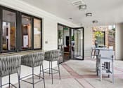 Thumbnail 25 of 53 - Two grey chairs are placed on a patio.
