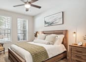Thumbnail 14 of 40 - a bedroom with a large bed and a ceiling fan