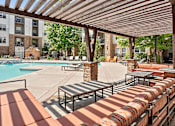 Thumbnail 15 of 40 - our apartments have a resort style pool and lounge furniture