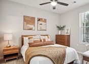 Thumbnail 24 of 40 - a bedroom with a bed and a ceiling fan