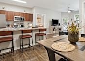 Thumbnail 3 of 40 - an open kitchen and dining room with a table and chairs