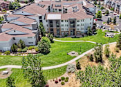 Thumbnail 33 of 40 - an aerial view of an apartment complex with a green park