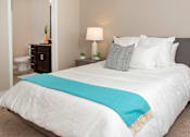 Thumbnail 6 of 27 - a bedroom with a large white bed and a blue blanket
