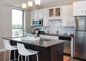 Thumbnail 1 of 27 - a kitchen with stainless steel appliances and a granite counter top