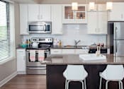 Thumbnail 3 of 27 - a kitchen with stainless steel appliances and a granite counter top