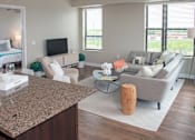 Thumbnail 2 of 27 - a living room with couches and chairs and a table