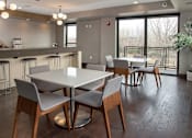Thumbnail 25 of 27 - Community kitchen with bar, two square tables with chairs
