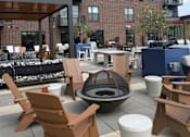 Thumbnail 40 of 45 - A patio with chairs and a fire pit.